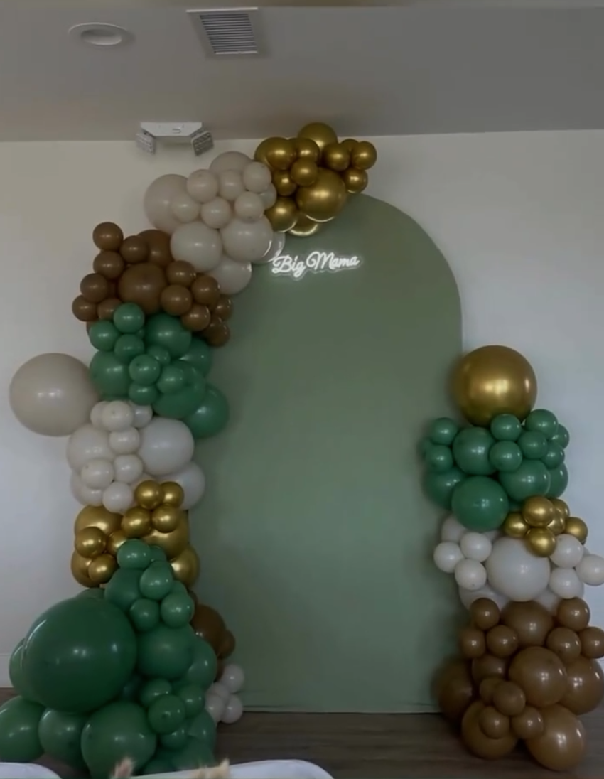 Green and gold balloon arch by Mixed Occasions